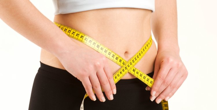 woman-crossing-measuring-tape-at-waist